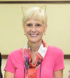 woman smiling at camera wearing cat ears