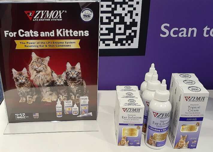 Zymox Cats and Kittens sign with boxes and squeeze bottles of Zymox products sitting next to it.