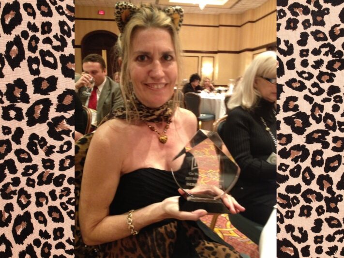 Deb holding a crystal award, for 2013 Writer of the Year in Irving, Texas.
