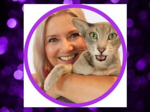 close up of woman's face holding gray cat in her arms