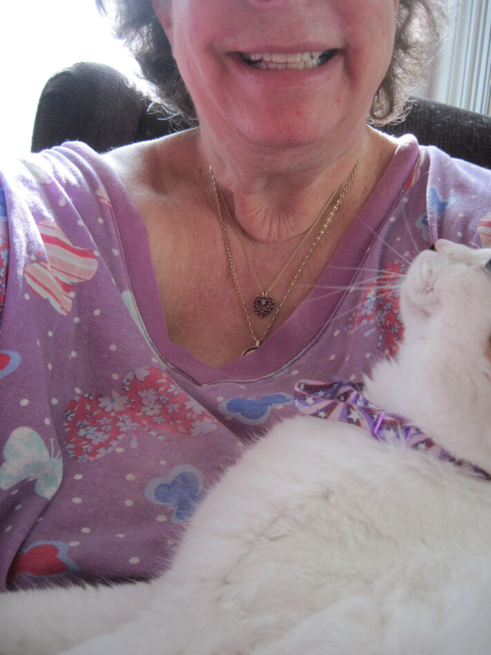 woman holding white cat