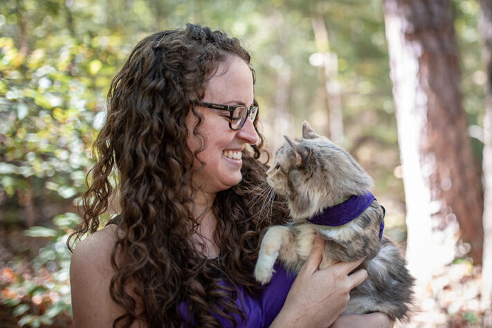 woman holding cat oustide