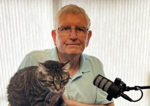 Clark Greer and his cat Maddie at microphone